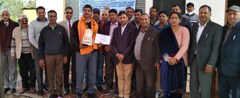 Dignitaries honouring Ajay Kumar of Barnoti, Kathua for his efforts for water conservation on Thursday.