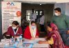 A doctor prescribing medicines to a patient during a health checkup camp at Gurudwara Ashram Digiana in Jammu.