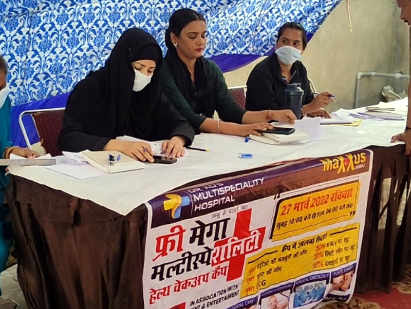Doctors providing their services during a health camp at Jammu on Sunday.