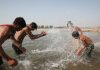 Children enjoy in Tawi water during a hot day in Jammu. —Excelsior/Rakesh