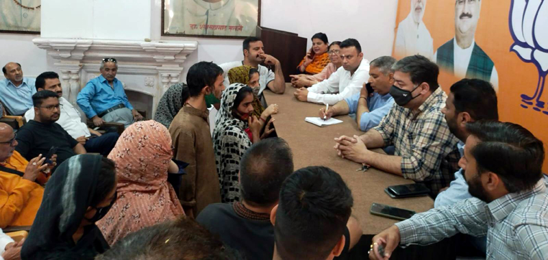 BJP senior leader, Sat Sharma talking to delegations of people at Kachi Chawni office on Friday.