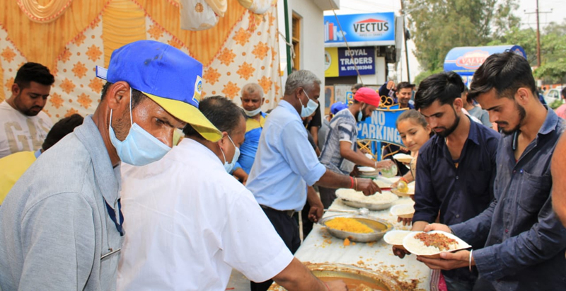 People take food at a Bhandara organised by K.N Filling Station in Bantalab. People take food at a Bhandara organised by K.N Filling Station in Bantalab.