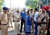 DC Sakshi Sawhney along with SSP Nanak Singh stand the outside Kali Mata temple after clash between two groups in Patiala on Saturday. (UNI)