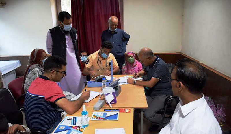 Doctors examining patients during medical camp.