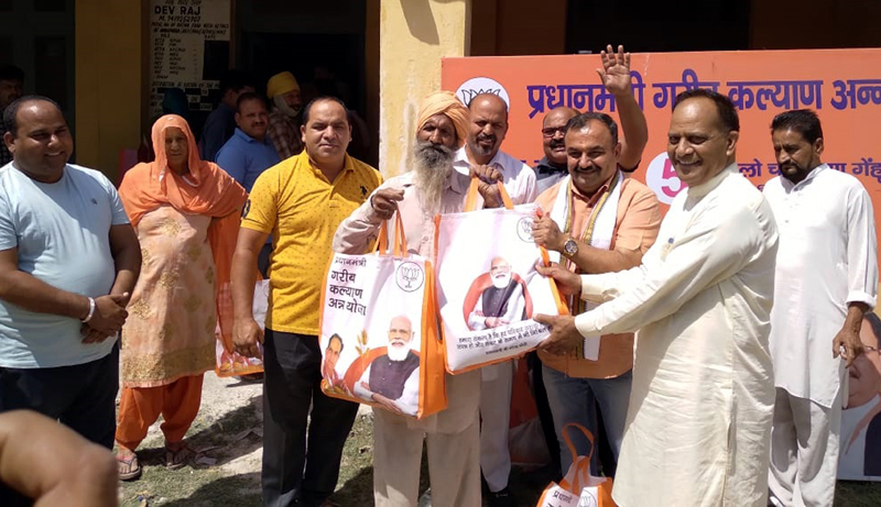 Senior BJP leader and former MLC, Ch Vikram Randhawa distributing ration among people at Panchayat Kullian on Sunday. Senior BJP leader and former MLC, Ch Vikram Randhawa distributing ration among people at Panchayat Kullian on Sunday.