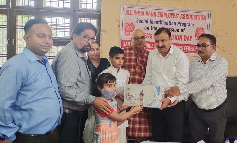 Members of Jammu Province Bank Employees Federation giving milk and biscuits to children at Balika Nikaten on Wednesday. Members of Jammu Province Bank Employees Federation giving milk and biscuits to children at Balika Nikaten on Wednesday.