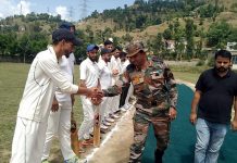 Army officer interacting with players.