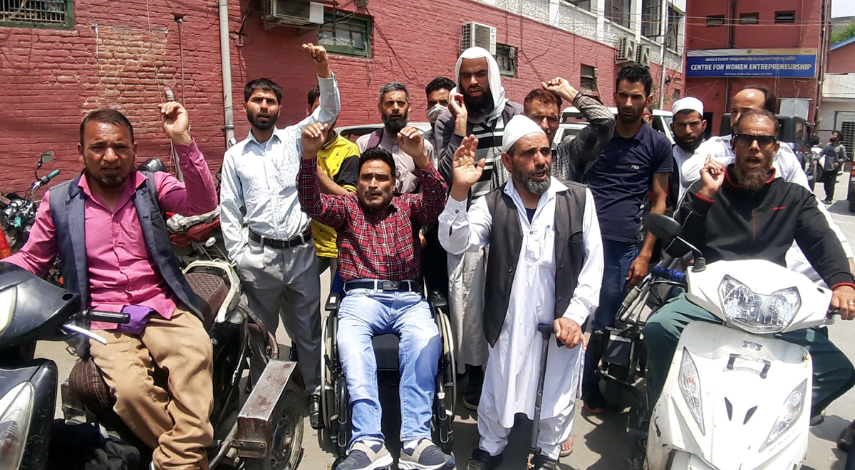 J&K Handicapped Association staging protest at Press Colony in Srinagar on Tuesday. -Excelsior/Shakeel