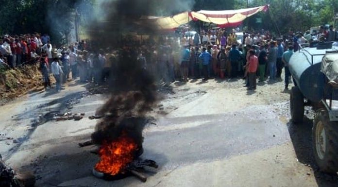 People block Jammu-Poonch highway near Sunderbani on Wednesday.