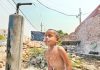 A boy baths under water pump on a hot summer day on the outskirts of Jammu. - Excelsior/Rakesh