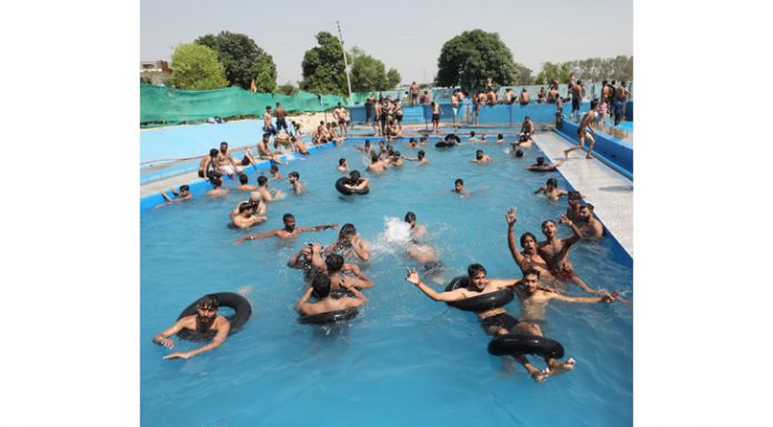 People enjoying in pool on a hot summer day on the outskirts of Jammu. -Excelsior/Rakesh