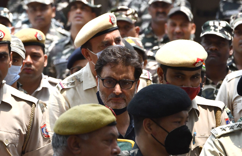 JKLF chief Yasin Malik being escorted by security personnel at Patiala House court in New Delhi on Wednesday. (UNI)