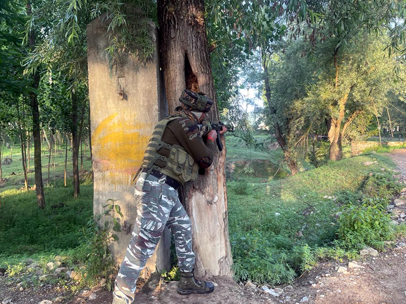 Security forces take position at the encounter site in Awantipora on Friday. (UNI)