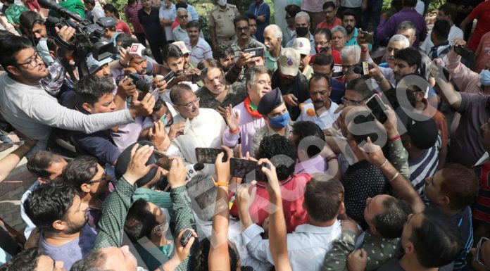 J&K BJP chief Ravinder Raina and senior BJP leader Kavinder Gupta surrounded by angry crowd at Bantalab crematorium in Jammu on Friday.