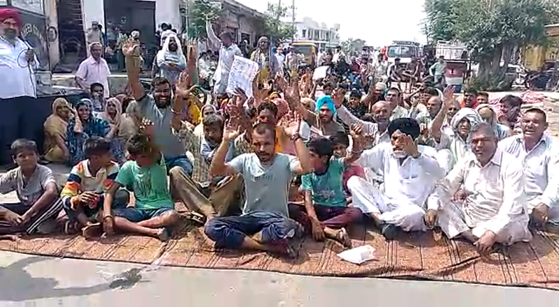 Residents raising slogans during protest. Residents raising slogans during protest.