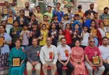 Winners displaying trophies and medals while posing with dignitaries at Sprawling Buds ICSE School Bantalab Jammu on Sunday.