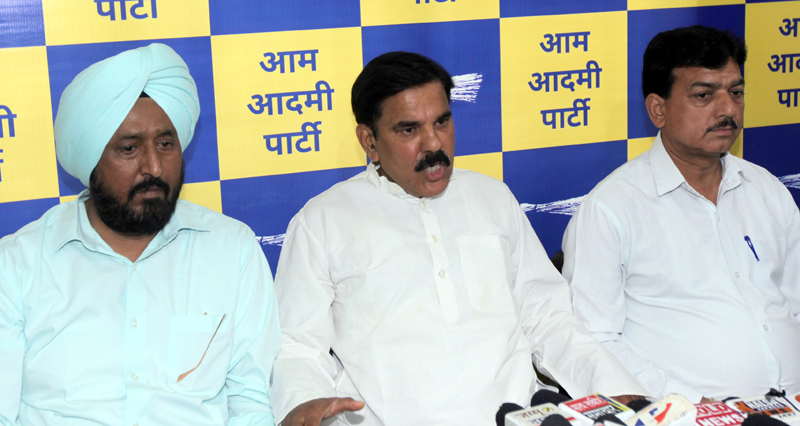 AAP leaders Harsh Dev Singh accompanied by Y P Kundal and T S Tony addressing press conference in Jammu. -Excelsior/Rakesh AAP leaders Harsh Dev Singh accompanied by Y P Kundal and T S Tony addressing press conference in Jammu. -Excelsior/Rakesh