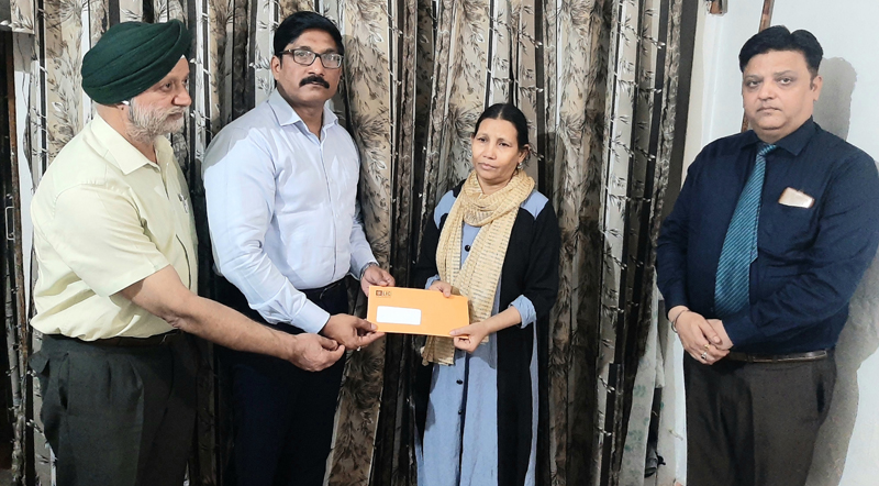 Branch Manager, Jammu-1, LIC Rajesh Kumar Nagar and fellow colleagues handing over the letter of payment of claim.