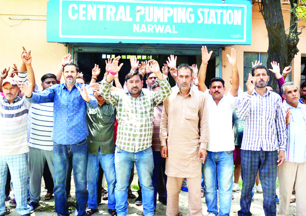PHE workers staging protest demonstration at Narwal Pumping Station in Jammu on Thursday. -Excelsior/ Rakesh