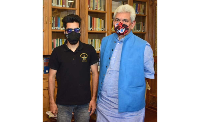 Lt Governor Manoj Sinha and Para Athlete Irfan Ahmed Mir posing for photograph at Raj Bhavan in Srinagar. Lt Governor Manoj Sinha and Para Athlete Irfan Ahmed Mir posing for photograph at Raj Bhavan in Srinagar.