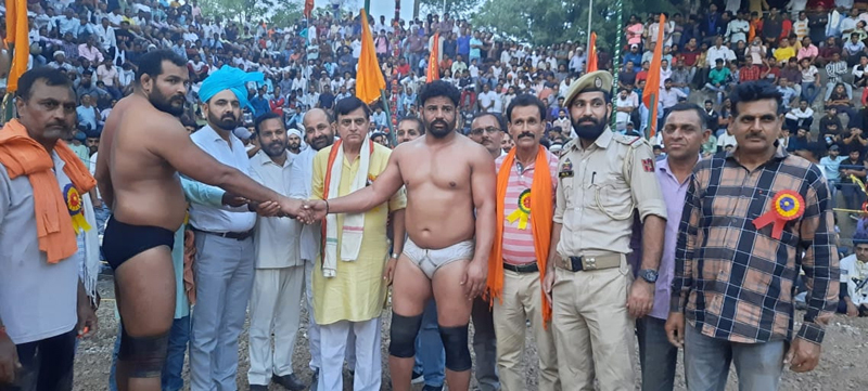 Dignitaries and wrestlers during Annual Wrestling Competition.