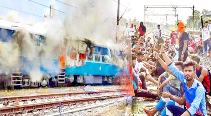 Protesters torch train in Bihar on Thursday during protest against the Centre’s new Agnipath scheme.