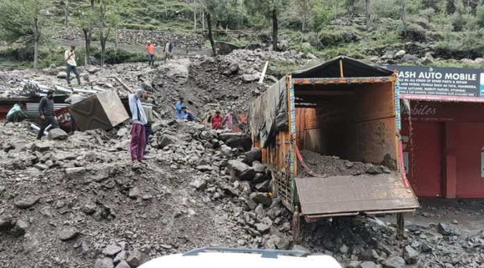 A truck trapped in debris after cloudburst in Mandi area of Poonch on Sunday. — Excelsior/ Ramesh Bali