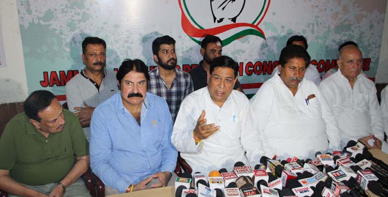PCC chief spokesperson Ravinder Sharma, flanked by senior party leaders, addressing press conference in Jammu. -Excelsior/Rakesh PCC chief spokesperson Ravinder Sharma, flanked by senior party leaders, addressing press conference in Jammu. -Excelsior/Rakesh