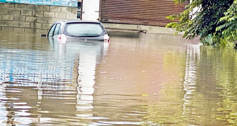 A car submerged in water on Kulgam road in Kashmir. -Excelsior/Sajad Dar