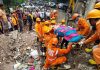 NDRF workers rescue a woman from the site of the four-storey building collapse, at Naik Nagar in Kurla East, Mumbai.