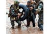 A youth being rescued from flooded river by Army jawans near Poonch on Sunday. -Excelsior/Romesh Bali