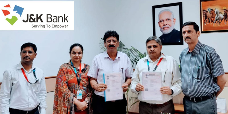 Office bearers of J&K Bank and Omkar Nests displaying copy of agreement at Jammu on Tuesday.