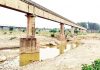 Illegal mining done under the Ravi Tawi canal aqueduct on river Basanter has exposed this super structure to a grave risk. -Excelsior / Nischant