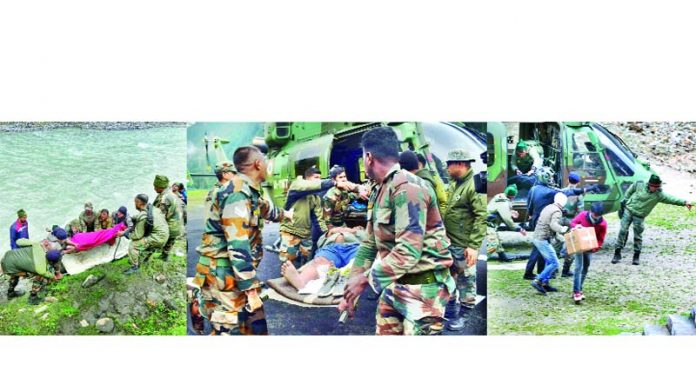 Rescue teams shifting injured to Army hospitals from cave shrine area on Saturday. -Excelsior pics by Shakeel & Aabid Nabi