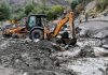 A JCB clearing mud and stones from village Stakpa in Kargil, hit by flash flood on Tuesday. — Excelsior/Basharat Ladakhi