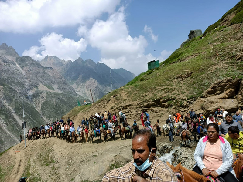 Amarnathji pilgrims trekking a hill on way to holy cave on Saturday.