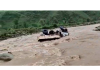 A tipper washed away in Darhali Nallah near Aitti in Rajouri on Friday. -Excelsior/Bhat
