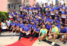 Runners posing for a group photograph along with officials at Jammu on Tuesday.