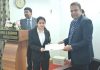 Justice Wasim Sadiq Nargal handing over an enrolment certificate to a newly enrolled advocate at Jammu.
