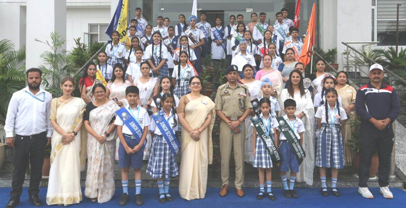 ADGP Jammu Mukesh Singh posing for a group photograph along with students and staff members of Jammu Sanskriti School on Friday.