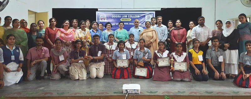 Winners displaying certificates while posing for a group photograph with dignitaries. Winners displaying certificates while posing for a group photograph with dignitaries.