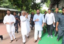 Janata Dal (United) leader Nitish Kumar with Rashtriya Janata Dal leaders Tejashwi Yadav and Tej Pratap in Patna on Tuesday. (UNI)