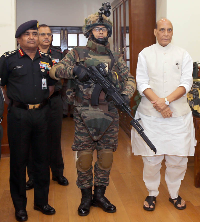 Defence Minister Rajnath Singh handing over indigenously-developed Future Infantry Soldier as a System (F-INSAS) to Chief of the Army Staff General Manoj Pande, in New Delhi on Tuesday. (UNI)