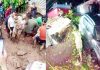 Two children’s bodies being removed from collapsed house in Billawar (left) and cars stuck with houses after massive flash flood in Surankote on Sunday (right). —Excelsior pics by Pardeep & Romesh Bali