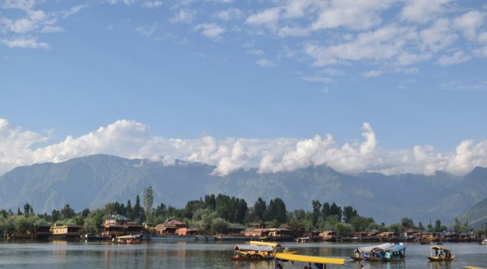 Tourists and locals enjoying shikara ride under cloudy sky at Dal lake in Srinagar. —Excelsior/Shakeel