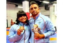 Divya Kakran posing photograph with wrestling coach Sahil Sharma.