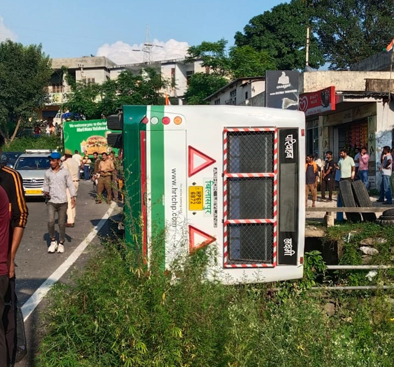 A bus over turns on the road after colliding with another bus near Katra on Tuesday. -Excelsior/ Ramesh Mengi A bus over turns on the road after colliding with another bus near Katra on Tuesday. -Excelsior/ Ramesh Mengi