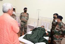 Lieutenant Governor, Manoj Sinha enquiring about the health of Pitambar Nath Pandit in hospital.