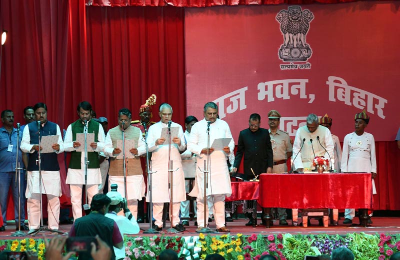 Bihar Governor Fagu Chauhan administering the oath of office to RJD's Tej Pratap, Alok Mehta, Bijendra Yadav and Vijay Chaudhary during the swearing-in ceremony for expansion of the cabinet of the Grand Alliance government , in Patna on Tuesday. (UNI)