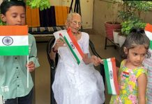 Heeraben Modi, mother of Prime Minister Narendra Modi distributes national flag to children and hoists the tricolour as the Har Ghar Tiranga campaign begins today.